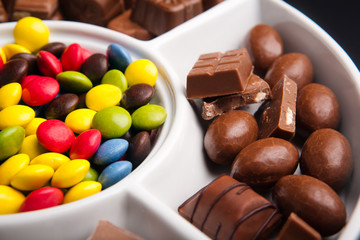 Colorful chocolate sweets with random pieces of chocolate