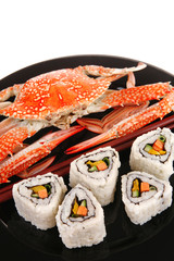 Maki Rolls and California rolls on black with prepared crab