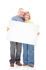 Senior happy couple with placard.