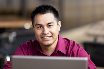 Hispanic Businessman - Telecommuting from Internet Cafe