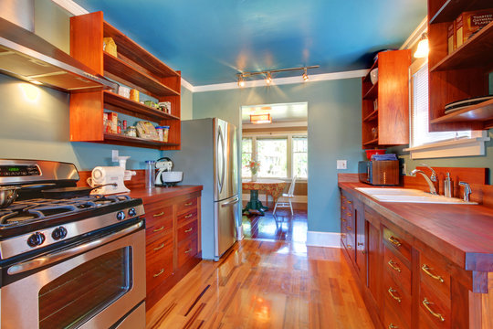 Shiny custom build kitchen with cherry wood.