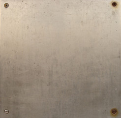 screwed metal plate sheet with some rust and wear