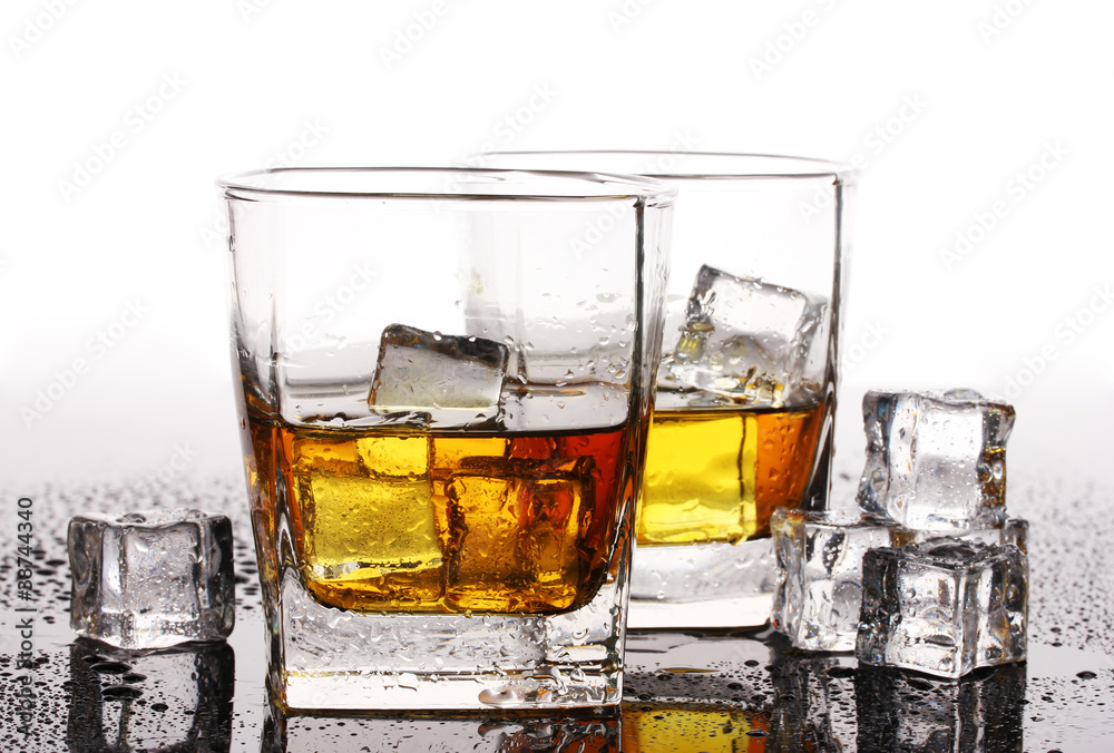 Poster two glasses of scotch whiskey and ice on table isolated on white