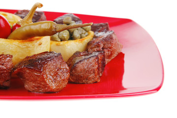 food: roast beef meat over red plate