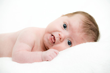 Close up portrait newborn baby lying in bed