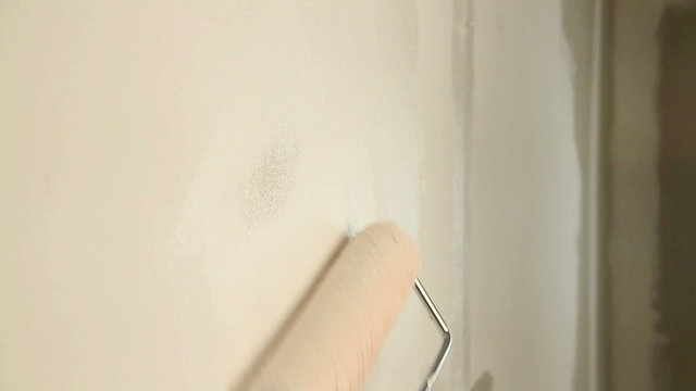 Painting out a bare wall with a paint roller