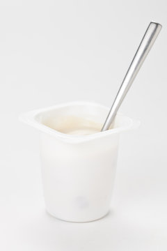 yogurt in plastic box container over white background