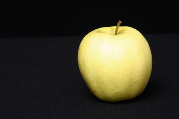 Gold apple on a black background