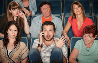 Man On Phone In Theater