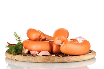 tasty sausages on wooden board and spices isolation on white