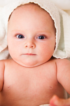 Cute infant girl happy in white towel