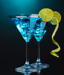Blue cocktail in martini glasses on blue background