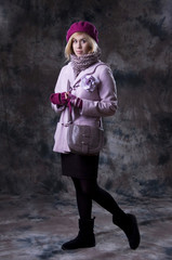 Portrait of beautiful girl in lilac coat.