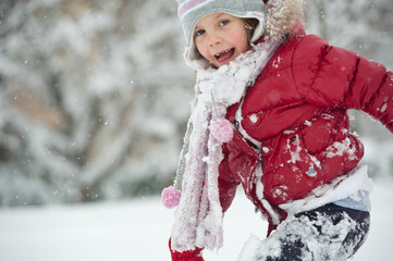 Young girl playing in the snow.