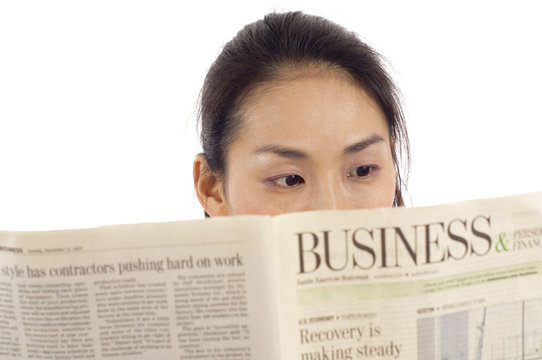 Asian Woman Reading Newspaper