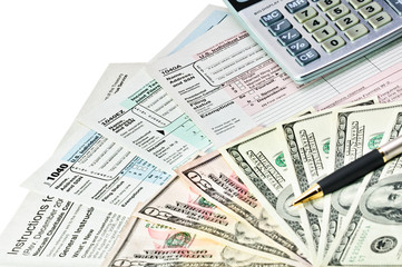 Tax forms 1040 and money.