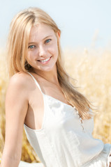 Happy woman on picnic in wheat field