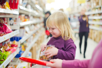 Mother and daughter in bakery section of supermarket. Daughter w