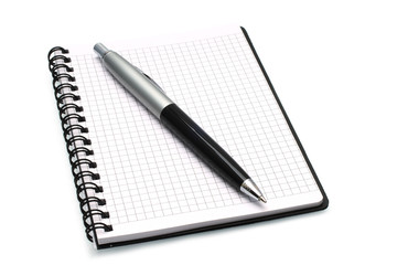 Notepad with ball pen on a white background