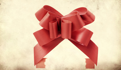 Big red holiday bow on grunge background