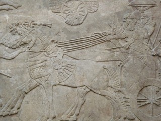 Ancient Assyrian wall carvings of men and horses
