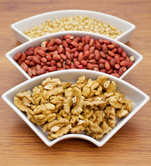 White plats with walnuts, peanut and pine nut