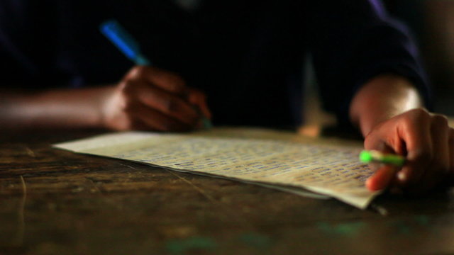 A Close up of a student doing classwork in Kenya.
