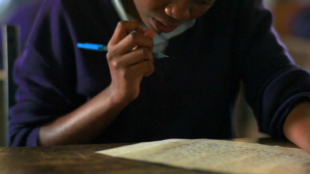 Close up of a student working in class in Kenya.
