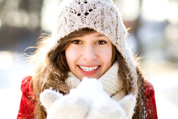 Smiling woman holding snow