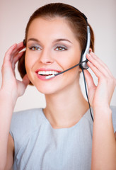 Naklejka premium Young attractive business woman with headset