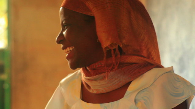 Close up of a teacher in a full classroom in Kenya.