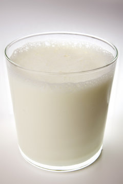 Glass of milk on gray surface