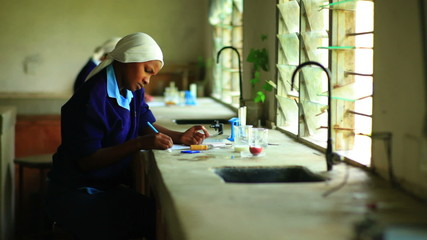 African school girls studying chemistry in Kenya, Africa. - Powered by Adobe
