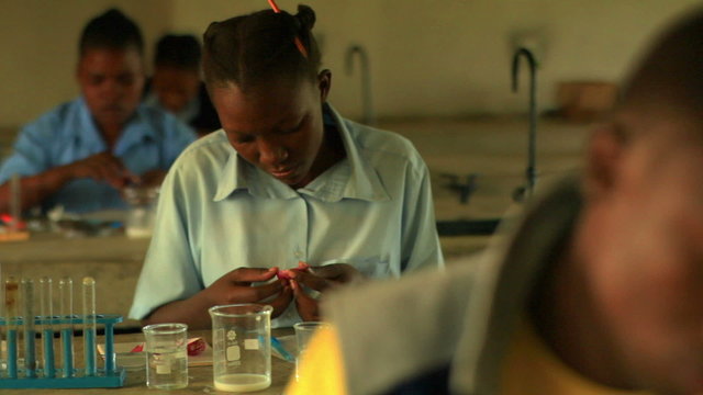 Students practicing chemistry in Kenya school, Africa