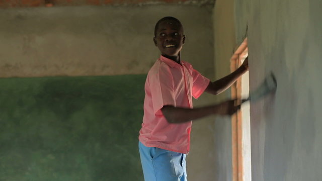 Painting the interior of a school in a village in Kenya.