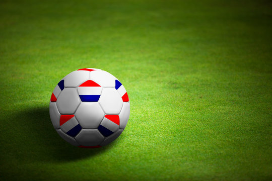 Flag of Netherlands with soccer ball over grass - Euro 2012