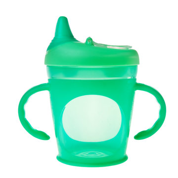 Green baby plastic cup with handles over white background.