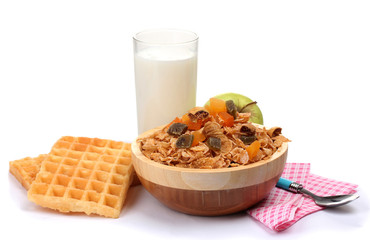 tasty cornflakes in wooden bowl, apples and glass of milk