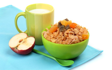tasty cornflakes in green bowl, apple and glass of milk isolated