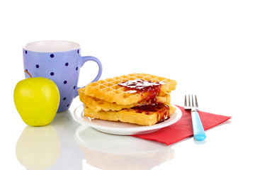 Tasty waffles with jam on plate isolated on white