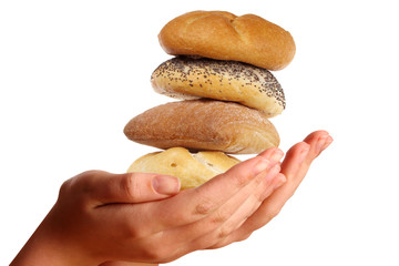 Two young hands offering a pile of buns