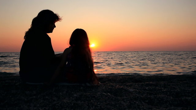 Family is sitting on the beach HD
