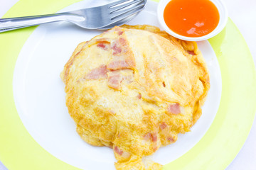 Rice, topped with omelette, dip chili sauce.