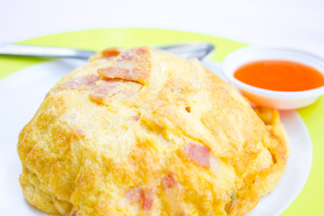 Rice, topped with omelette, dip chili sauce.