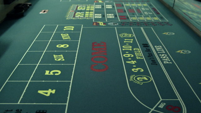 Dice rolling across a craps table.