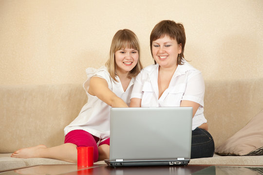 women using laptop in home