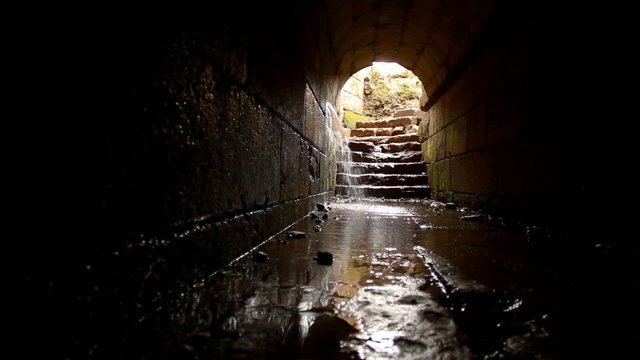 Stock Video Footage of water pouring into an ancient underground tunnel in Israel.
