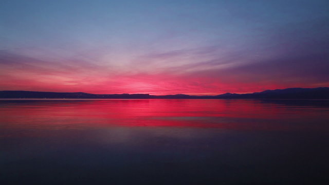 Stock Video Footage of the colorful sky reflected in the Sea of Galilee in Israel.