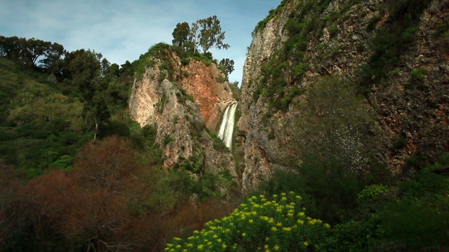 Stock Video Footage of the green and rocky setting of Iyon Tanur waterfall in Israel.