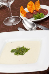 cream soup with potato chips and black pudding